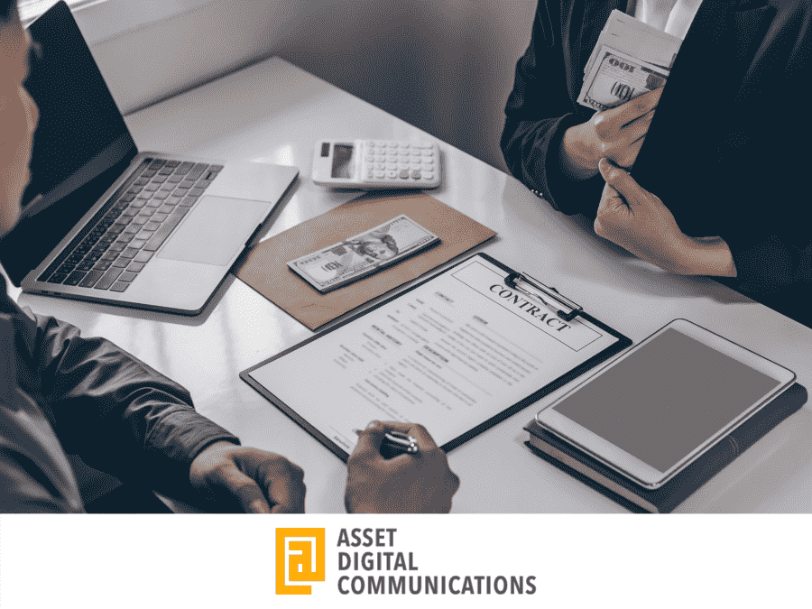 two people signing a contract